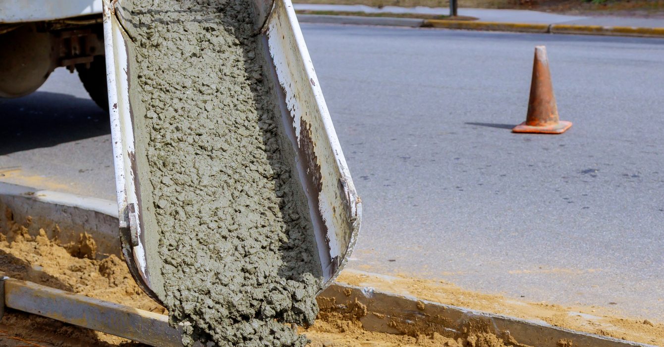 Concrete truck with pouring cement during to residential street